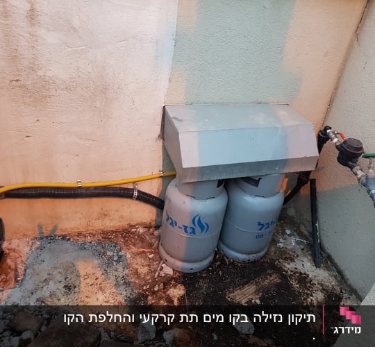 שני בלוני גז עם צינור צהוב וברז מים